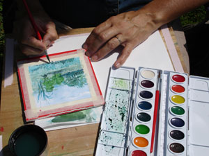Atrist hands using water color paints