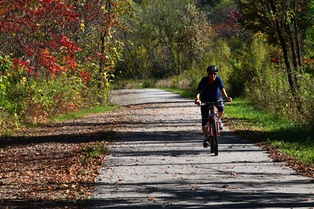 Biker on Old Hwy 131 Trail during Fall Colors